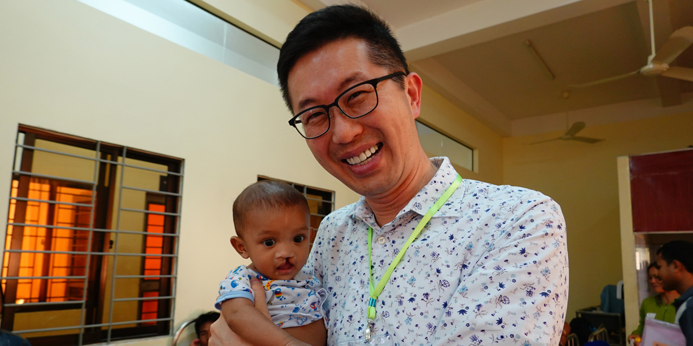Dr. Peter Pang and a child with an orofacial cleft <em>(Photo courtesy of interviewee)</em>